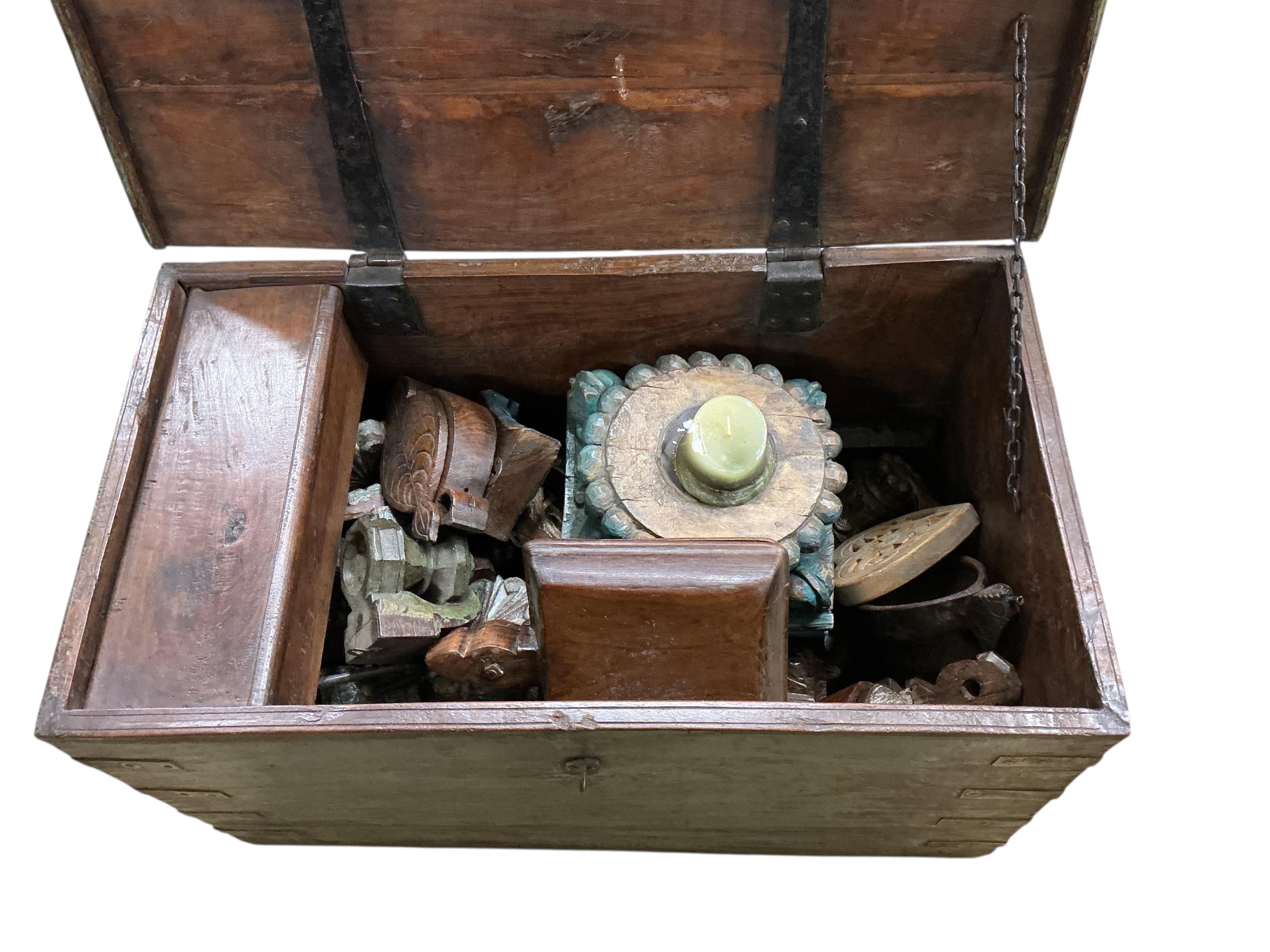 Two Indonesian iron bound hardwood trunks, larger width 80cm, depth 45cm, height 44cm together with a quantity of carvings